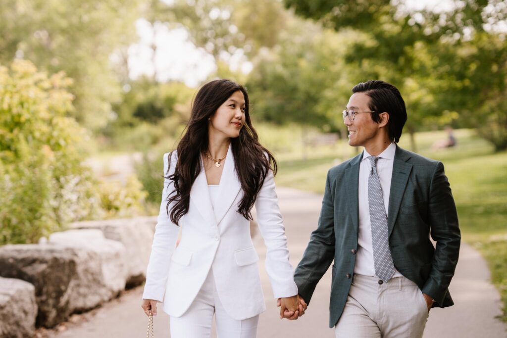 Bride and Groom holding hands in a park.